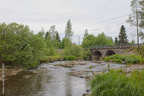 Rock bridge with two arches over river Hirvihaaranjoki in summer, Hirvihaara, Mäntsälä, Finland. photo