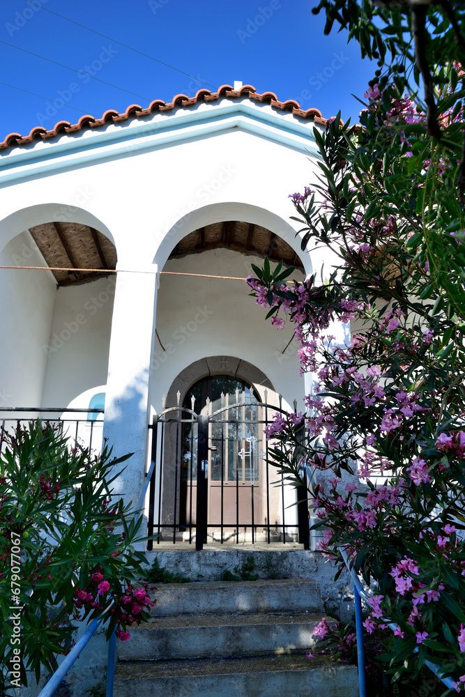 white Greek-Orthodox chapel with a flowered leander - Varos Village, Lemnos island, Greece, Aegean Sea