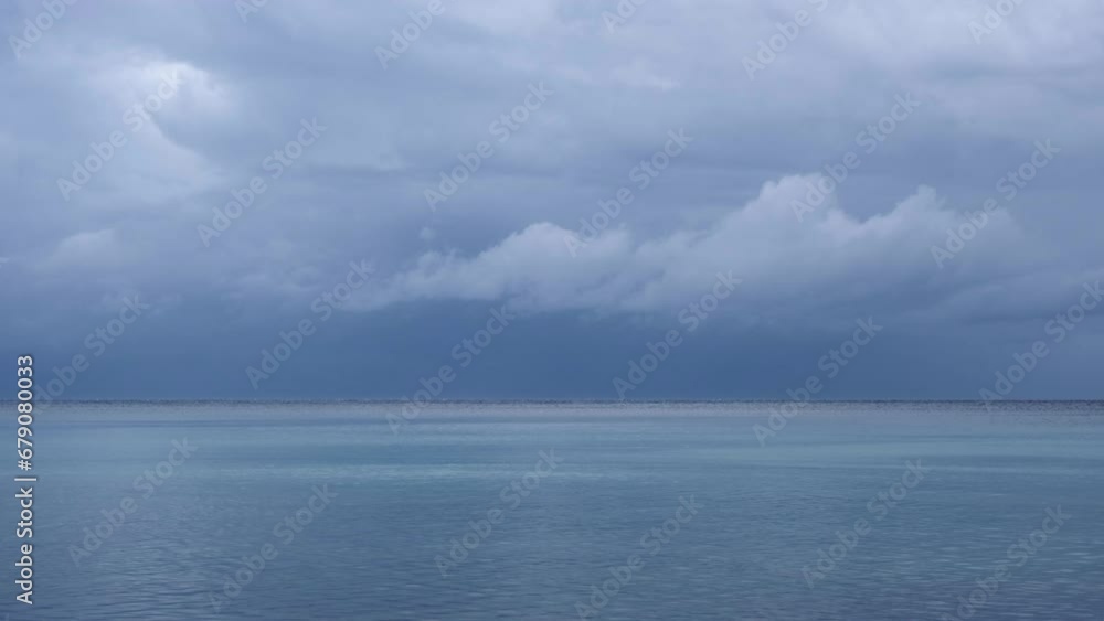 Magnificent nature landscape at the beach with amazing wind stripes on the water surface. Only blue and turquoise colours. Clouds moving above the mountains of Cres Island, Croatia on a stormy day. Magnificent nature landscape at the beach with amazing wind stripes on the water surface. Only blue and turquoise colours. Clouds moving above the mountains of Cres Island, Croatia on a stormy day.