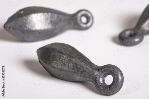 Lead fishing weights cast sinkers isolated on white background. Equipment or tools. Heap of lead sinker weights for fishing, silver bullet bank accessories, close up