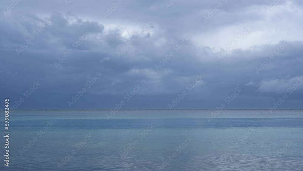 Magnificent nature landscape at the beach with amazing wind stripes on the water surface. Only blue and turquoise colours. Clouds moving above the mountains of Cres Island, Croatia on a stormy day. Magnificent nature landscape at the beach with amazing wind stripes on the water surface. Only blue and turquoise colours. Clouds moving above the mountains of Cres Island, Croatia on a stormy day.