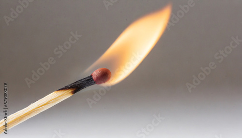 Macro photography of a burning match stick against white background