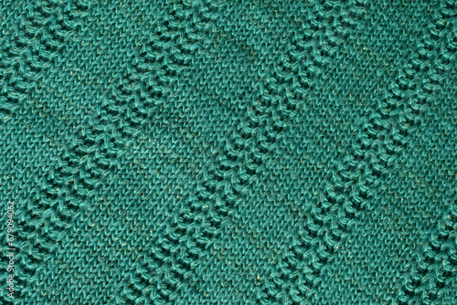  green knitted texture. Abstract background, pattern, ornament. Detail of a warm winter sweater.