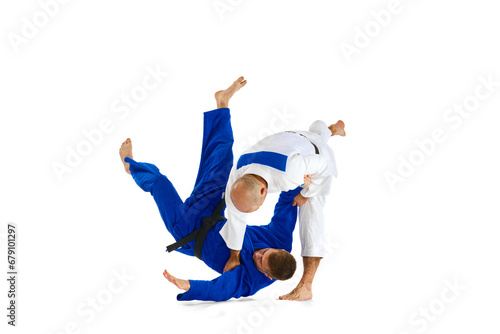 Two young man professional judoist fighting, performing technical skill isolated white studio background. Copy space for ad, text