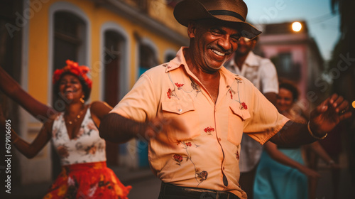Old happy Cuban enjoys music and salsa dance with family in the city © Paula