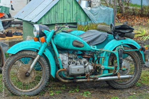 one old iron rusty classical heavy big comfortable green power broken dirty classic retro industrial motorcycle stands on the ground on the street 