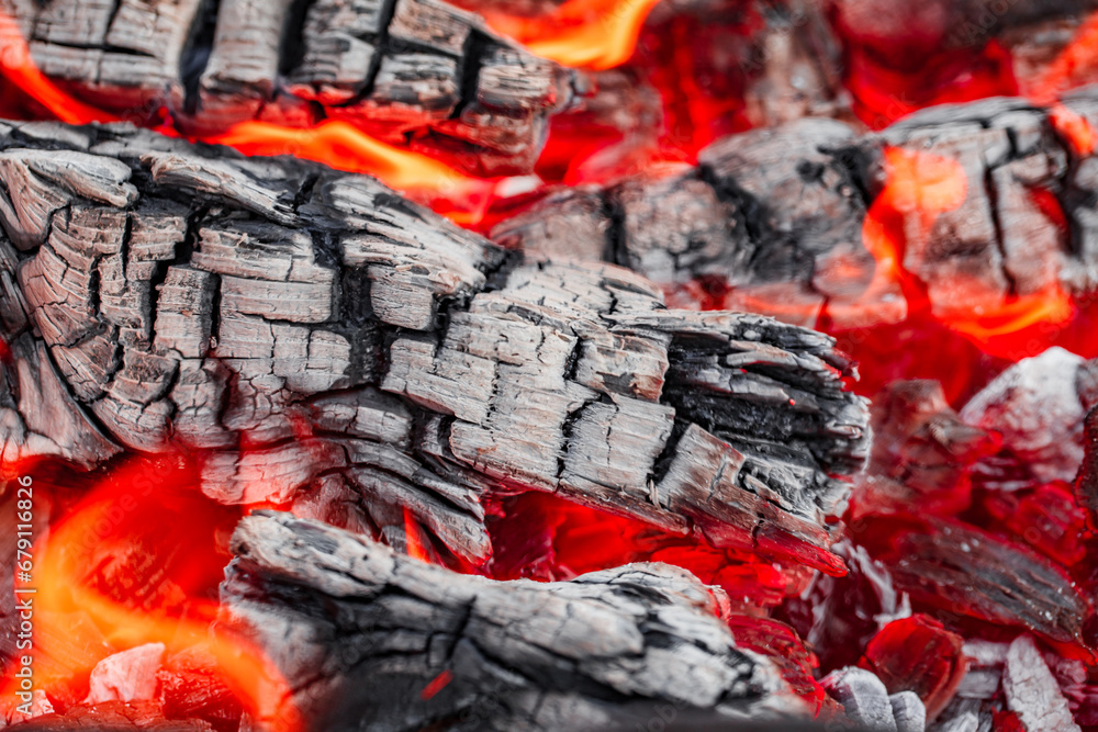 Burning red fire and smoldering charcoal close-up, selective focus, cracks Burning red fire and smoldering charcoal close-up, selective focus, cracks
