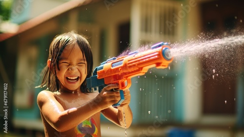 Children use water guns to play Songkran in summer photo
