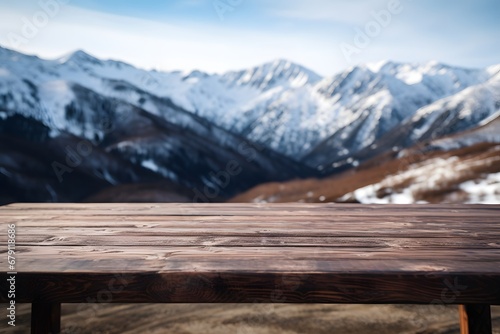 close up of a wooden table with the mountains covered with snow in winters