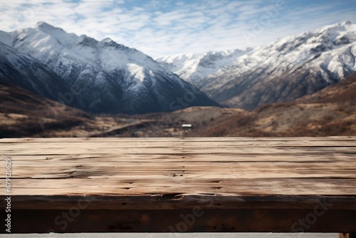 close up of a wooden table with the mountains covered with snow in winters © DailyLifeImages