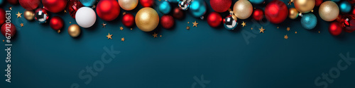 Christmas flat lay border with color glass balls, fir tree twigs and gift box, copy space on blue background