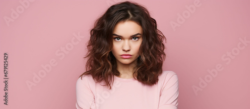Photo of unhappy young woman bad mood irritated problem raise eyebrow isolated on pink color background. Made with generative ai photo