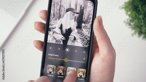 Woman editing her photo for social media. Stylizing images using an online app, choosing between different photo filters. Fictional interface. photo