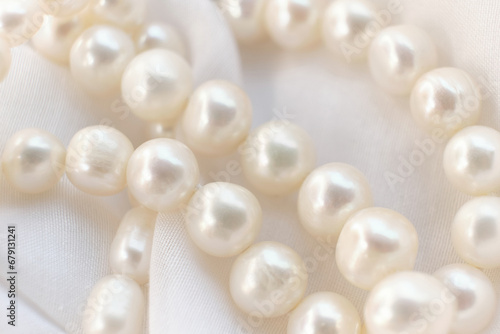The tender arrangement of pearls on a gentle white cloth exudes a serene aesthetic. It's a quiet protest against the glaring, artificial visuals that dominate modern digital platforms.