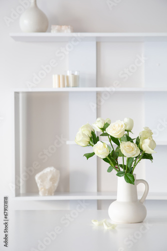 Fototapeta Naklejka Na Ścianę i Meble -  white roses in white jug in white interior