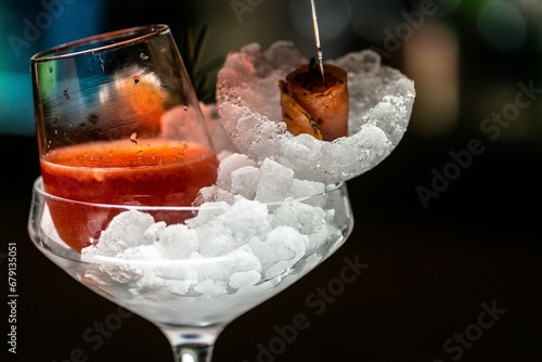 Canvas Print Glass of refreshing alcoholic beverage in a glass filled with ice cubes