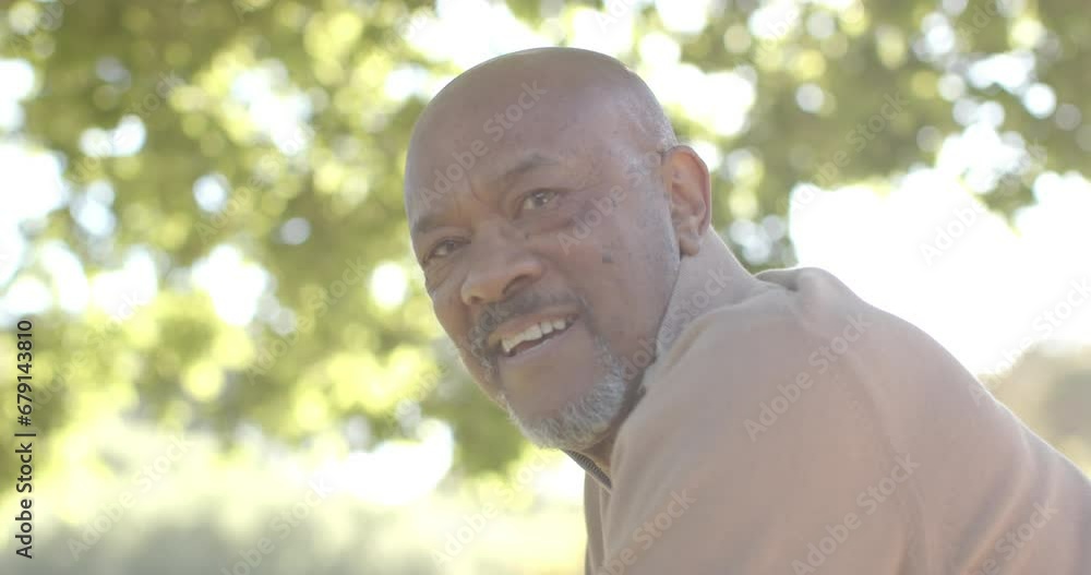 Portrait of happy senior biracial man at balcony at home over forest, slow motion Portrait of happy senior biracial man at balcony at home over forest, slow motion