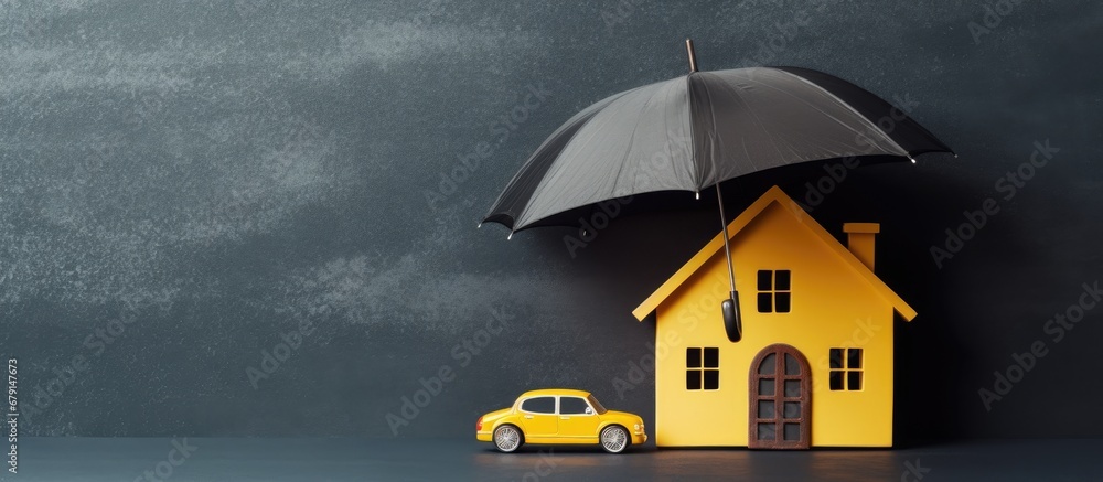 Insurance protects properties like cars and homes depicted as paper cutouts under a yellow umbrella on a blackboard background Copy space image Place for adding text or design - obrazy, fototapety, plakaty 