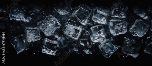 Ice cubes crushed on black background creating a chilling bottle shaped frame border Copy space image Place for adding text or design
