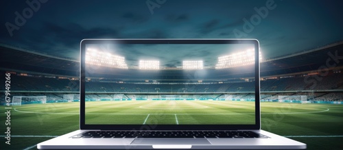 Laptop display promoting app or webpage with stadium backdrop Copy space image Place for adding text or design