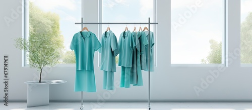 Hospital uniform for patients hanging on clothes rack used for hygiene purposes Copy space image Place for adding text or design photo