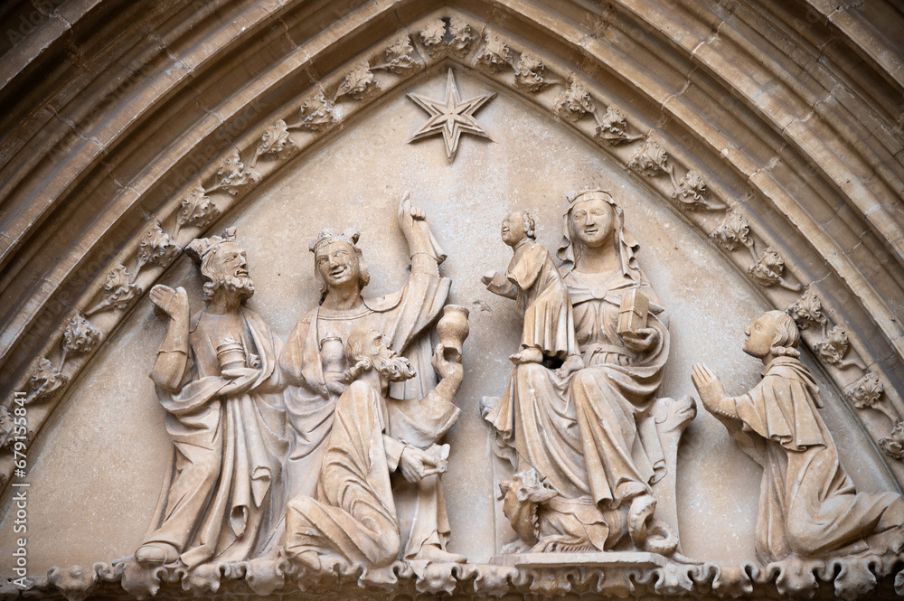 Vista del tímpano con la escena de la adoración de los Reyes Magos en el arco gótico de entrada a la iglesia de Ujué, Navarra, España.