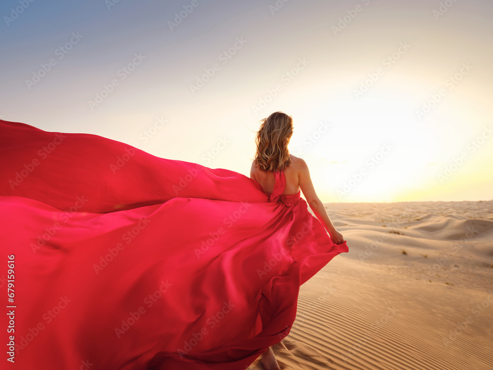 Woman in sands dunes of desert at sunset Woman in sands dunes of desert at sunset