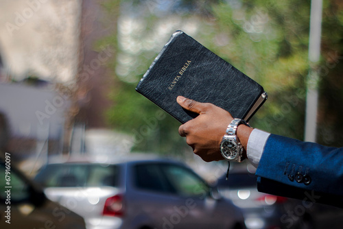 Hand up Holy Bible clock man