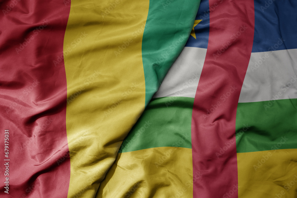 Obraz premium big waving national colorful flag of guinea and national flag of central african republic .