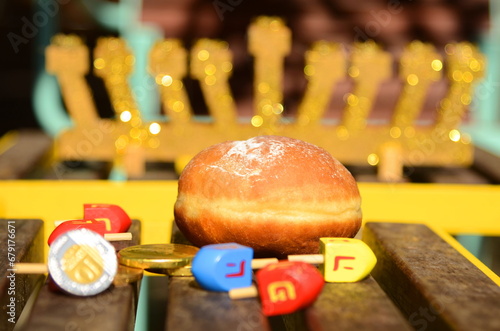 Hanukkah with wooden dreidels  menora   sufganiyot  Chanukiahm coins shekel. Attributes of the Jewish holiday. 