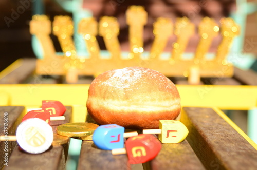 Jewish holiday Hanukkah. Holiday of light concept. Hanukkiah, menorah, dreidel, chocolate shekel coins, Sufganiyah photo