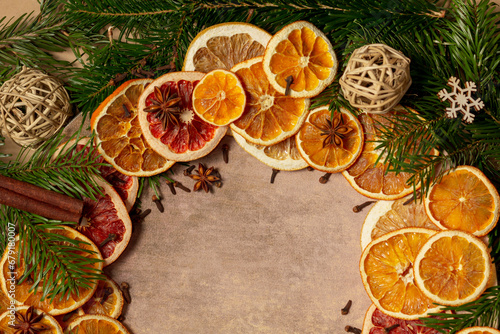 Christmas nature arrangement with dried orange pieces, cinnamon sticks, pine cones, star anise and Christmas tree branches