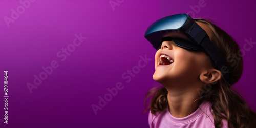 Young girl getting experience using VR headset glasses isolated on a blue background with copy space © dewaai