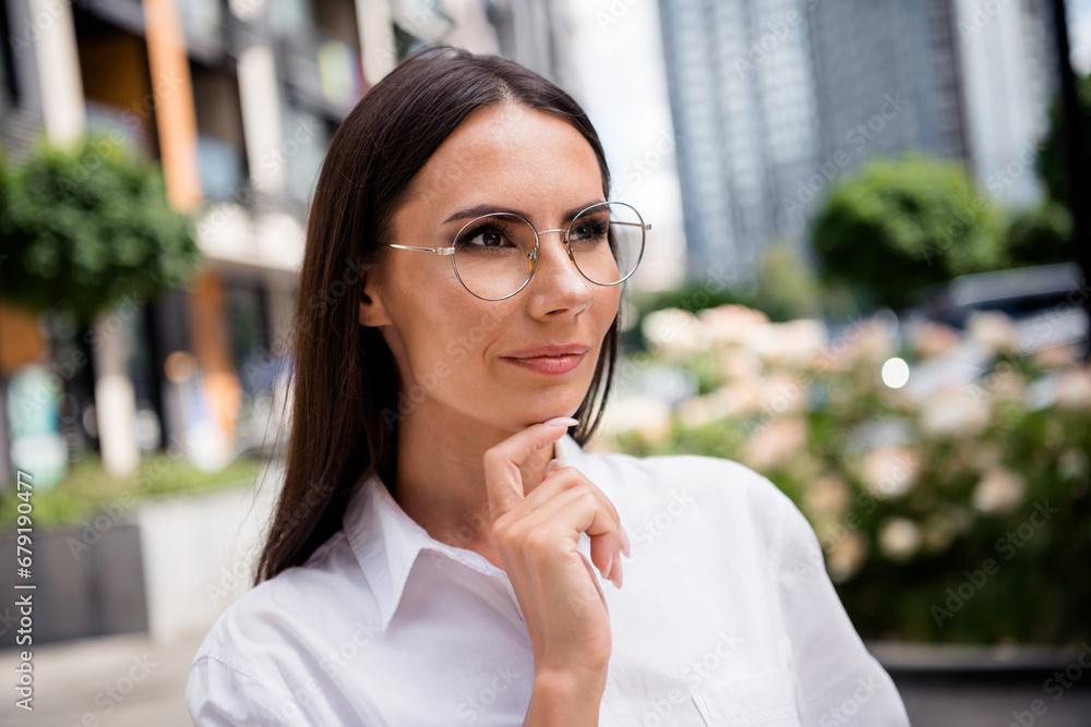 © deagreez - Photo of smiling smart lady realtor wear white shirt spectacles hand arm chin outside urban city street