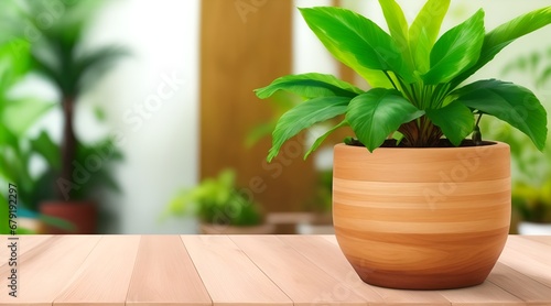 Wooden table, Complemented by a vibrant potted plant blurred background. Beautiful versatile backdrop for design and product presentation