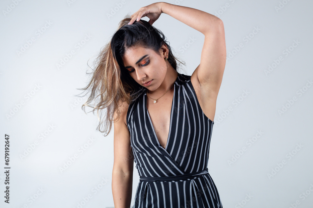modern fashion blonde female model wearing striped suit on colorful background isolated in photo studio modern fashion blonde female model wearing striped suit on colorful background isolated in photo studio