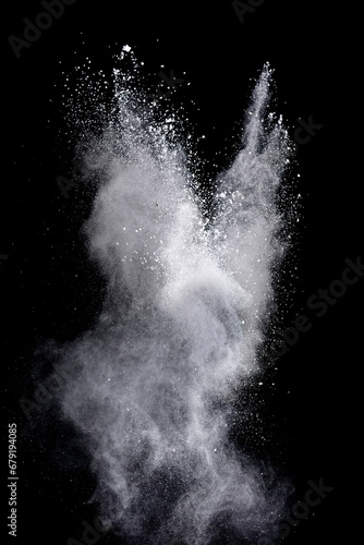 White powder explosion on black background. Colored cloud. Color dust explode. Paint Holi © piyaphong