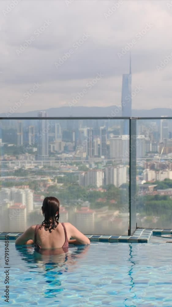 Young woman by an infinity pool, watching the sunrise skyline. Embracing mindfulness, relaxation, and facing a new day. Healthy and balanced lifestyle amid the city's stress Young woman by an infinity pool, watching the sunrise skyline. Embracing mindfulness, relaxation, and facing a new day. Healthy and balanced lifestyle amid the city's stress