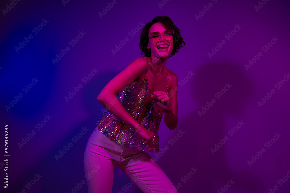 Photo of young girl wear shining crop top stylish sunglass boogie woogie enjoy night club occasion isolated on neon filter background
