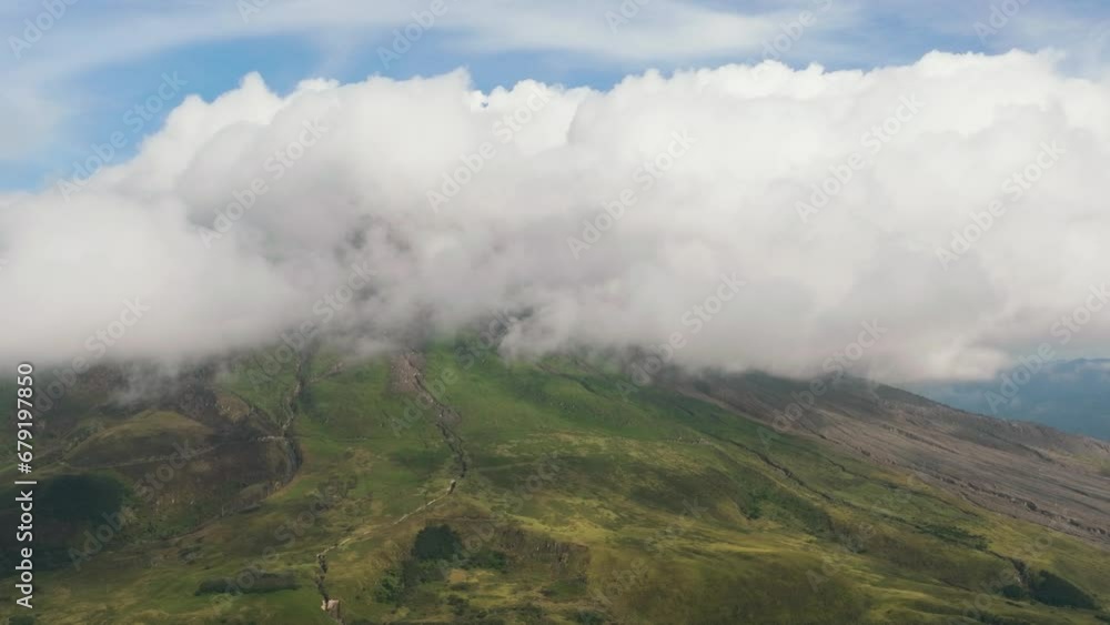 Aerial view of Sinabung volcano with slopes covered with clouds after the eruption. Sumatra, Indonesia. Aerial view of Sinabung volcano with slopes covered with clouds after the eruption. Sumatra, Indonesia.