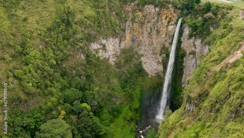 Waterfall in the tropical mountain. Sipiso Piso Falls in a mountain gorge. Sumatra, Indonesia. photo