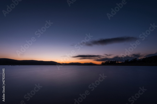 long exposure of the sunset on the lake shore