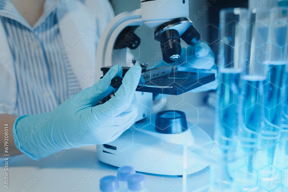 Fototapeta premium chemist is doing an experiment in the laboratory, A scientist is using a microscope to analyze the chemical composition, A scientific experiment is searching for biological answers in a laboratory,