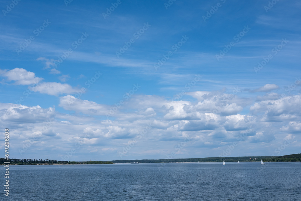 River summer landscape with clouds in the sky and sailing ships River summer landscape with clouds in the sky and sailing ships