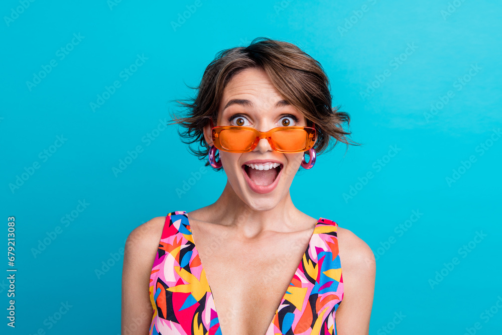 Photo of shocked excited girl dressed print outfit dark eyewear open mouth isolated blue color background