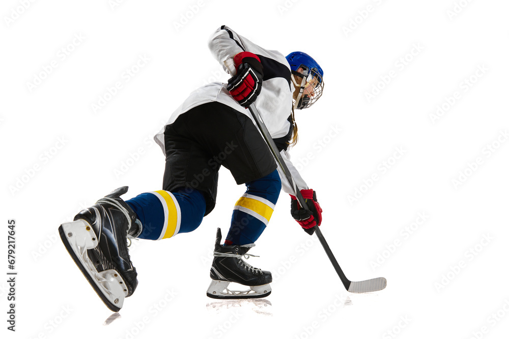 Fototapeta premium Young girl, athlete, hockey player in motion, training, playing isolated over white background. Championship. Concept of professional sport, competition, game, action and hobby