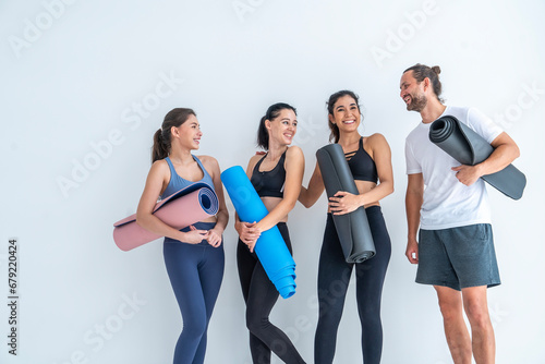 Health, lifestyle and exercise concepts.Group of people with exercise friends and female yoga instructor wearing sports clothes, exercising, trainer teaching yoga ้hold mat in exercise club studio