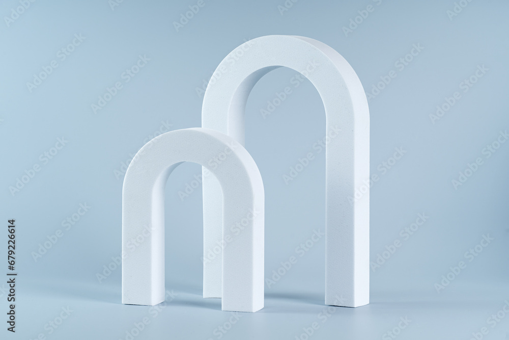 Two white archs for product presentation marketing on a blue background Two white archs for product presentation marketing on a blue background