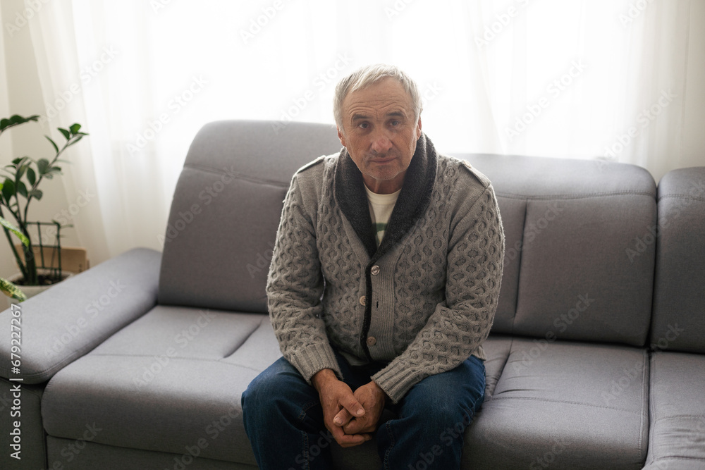 Elderly man grieves at home. Single people. Man upset headache Elderly man grieves at home. Single people. Man upset headache