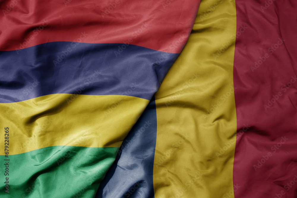 big waving national colorful flag of mauritius and national flag of chad . big waving national colorful flag of mauritius and national flag of chad .